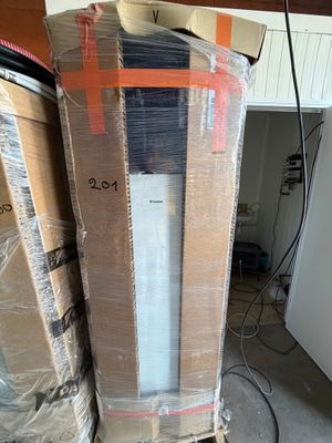 une grande pile de cartons et un réfrigérateur dans une pièce