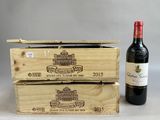a bottle of wine next to a wooden box of wine