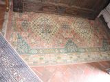 a rug on the floor in the corner of a room