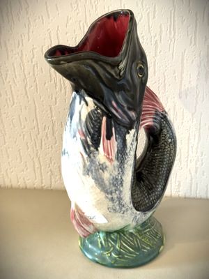 un vase contenant un poisson, posé sur une table