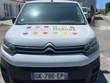 a white van with stickers on it parked in a parking lot