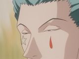 a man with blue hair and a red tear on his face