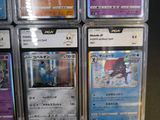 the pokemon cards are in the plastic case on the table