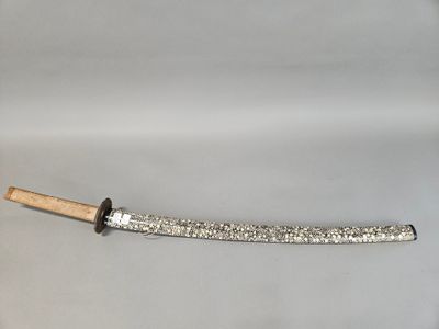 an old knife with a wooden handle on a white surface