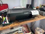 a printer sitting on top of a wooden desk