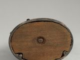 a close up of a small wooden object on a white surface