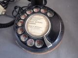 a telephone that is sitting on a table next to a pile of money
