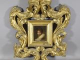 a gold frame with a picture of a child in it