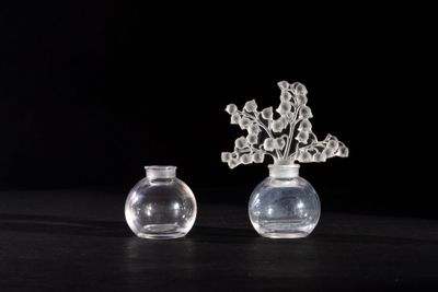 two vases with flowers in them sitting on a table