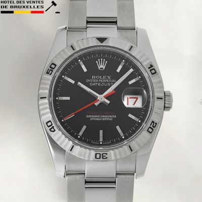 rolex watch with a black dial and red second hand