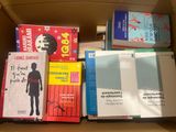 many books that are in a box on the table