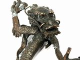 a bronze statue of a dragon holding a branch