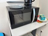 a microwave that is sitting on top of a shelf