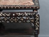 a small table with a marble top on it
