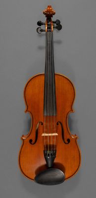 an old violin on a gray background with a bow on the back