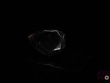 a close up of a black diamond on a black surface