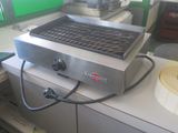 an image of a grill on a counter with a roll of tape on it