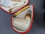 a red case with a pipe inside of it on a table