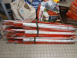 a pile of skis sitting on the ground next to bags
