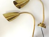 a pair of brass table lamps on a white background