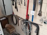 many tools hanging on the wall in the garage