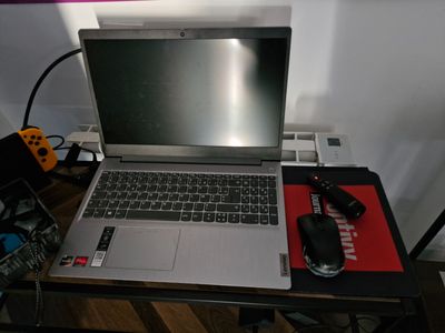a laptop computer sitting on top of a desk next to a mouse