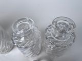 three clear glass vases sitting next to each other