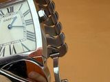 a person holding a wrist watch with a chain around it