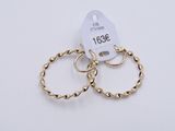 a pair of gold rings with a price tag on them