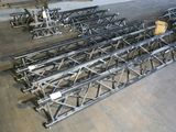 many metal trusses in a room with wooden flooring