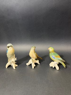 three figurines of birds sitting on top of each other