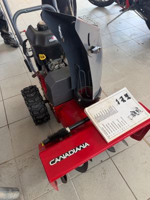 a snow blower sitting on the floor in a store