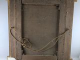 an old wooden frame with a rope hanging from it ' s sides