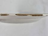 a close up of a white plate with holes in it