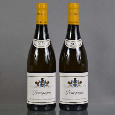 two bottles of wine sitting on top of a table next to each other