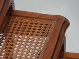 a wooden chair with a wicker seat on it