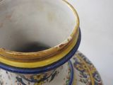 a close up of a vase and saucer on a table
