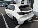 a small white car parked in a parking lot