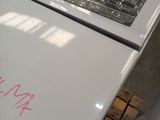 a white refrigerator with a pink sticker on it