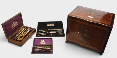 several different types of items are in a wooden box on a white surface