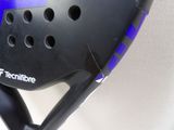 a close up of a tennis racquet with holes in it
