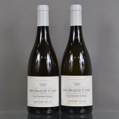 two bottles of wine sitting on top of a table next to each other