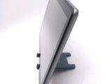 a tablet computer sitting on a stand on a white surface