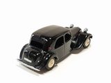 a black toy car that is sitting on a white surface