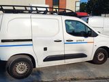 a white van parked in a parking lot next to a building