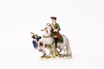 a figurine of a man riding a horse with a dog