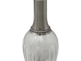 an image of a clear glass bottle with a metal stopper