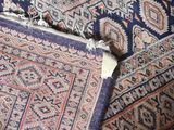 a close up of a rug with a piece of paper sticking out of it