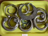 a yellow tray with a bunch of silver rings on it