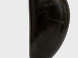 sculpture of a black and gold bird sitting on top of a white base